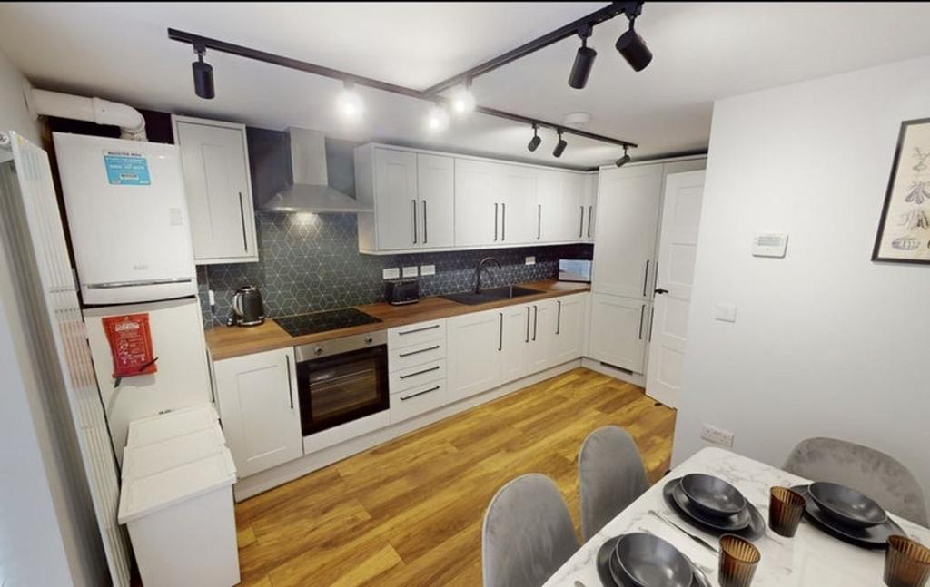 A modern kitchen featuring sleek cabinetry, a s...
