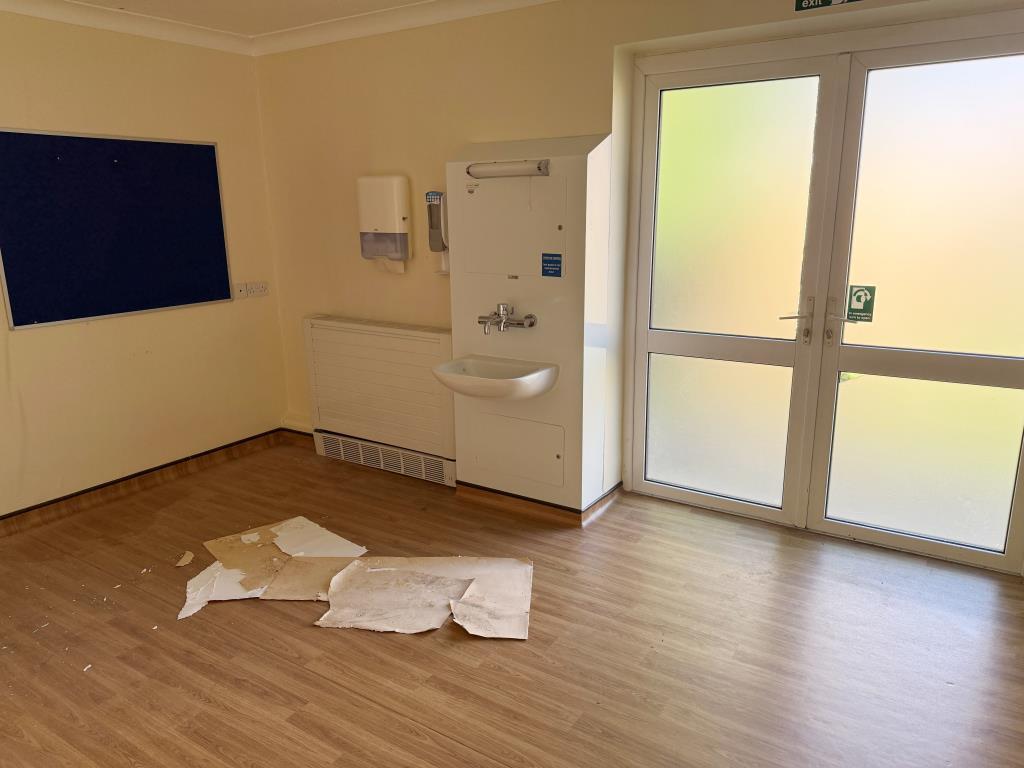 Consulting room with sink and doors to rear garden