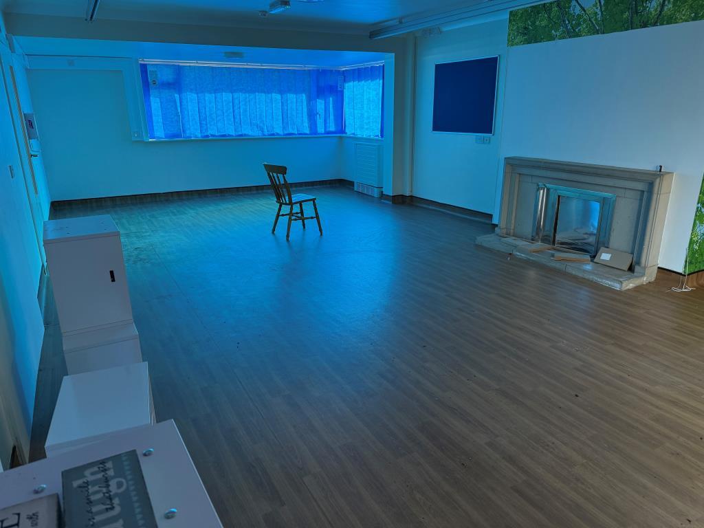 Day room with fireplace and window overlooking fro