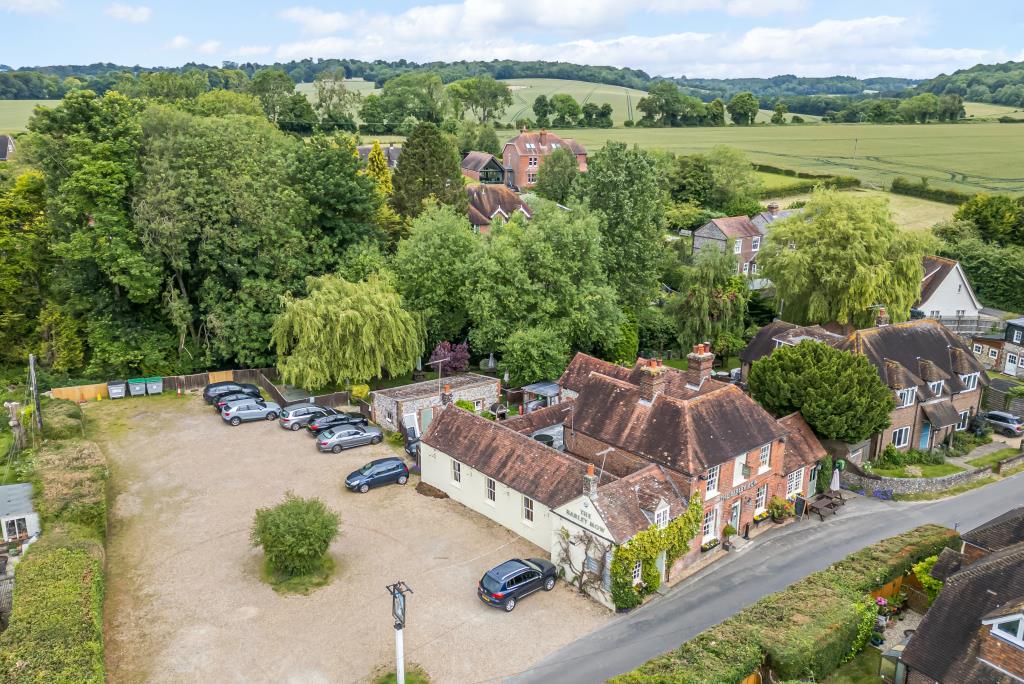Aerial view of pub with car park and gardens