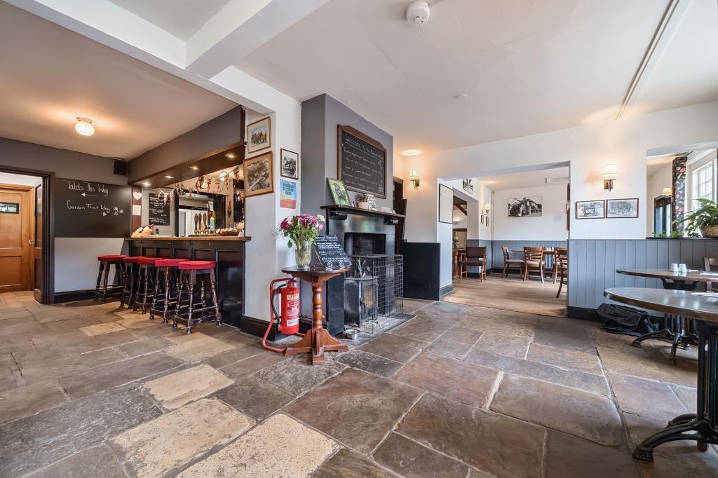 Flagstone flooring with stools and bar serving are