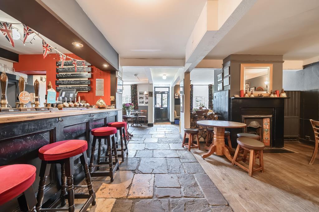 View of bar and entrance with seating