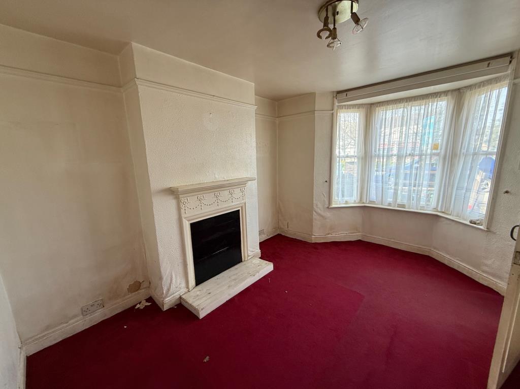 Living room with fireplace and bay window to the f
