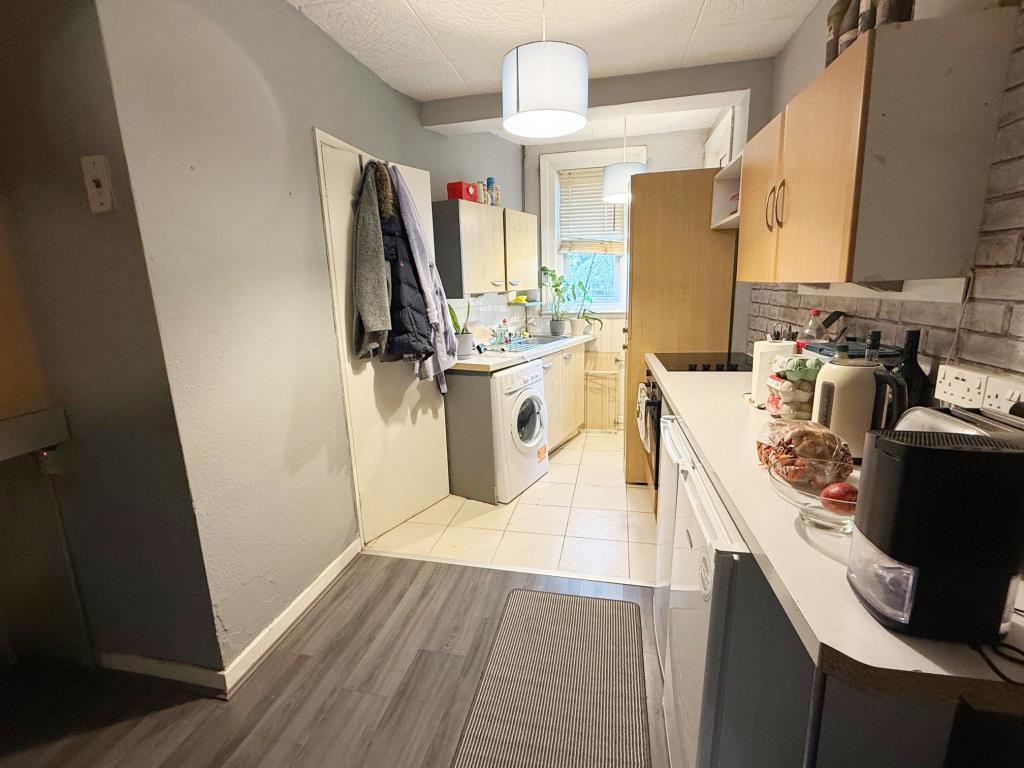 Kitchen area with door to shower room and door to