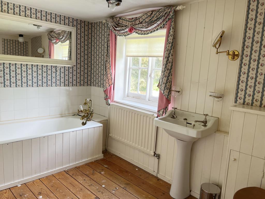 Bathroom with white suite and wooden floor