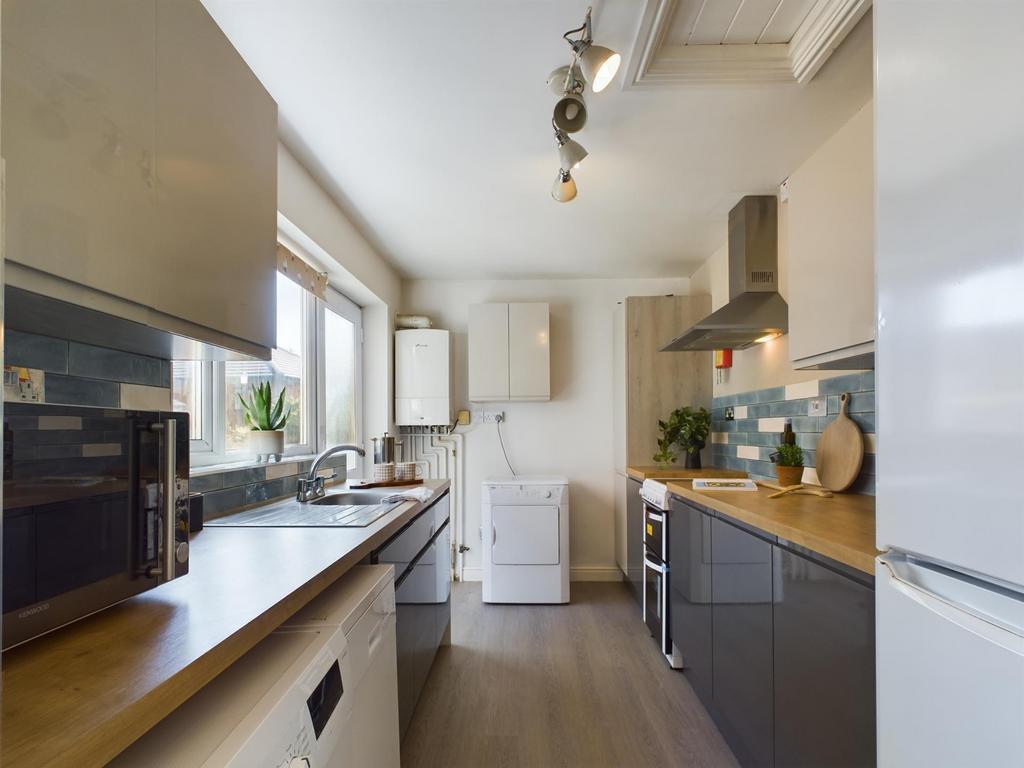 A bright and modern kitchen with ample natural ...