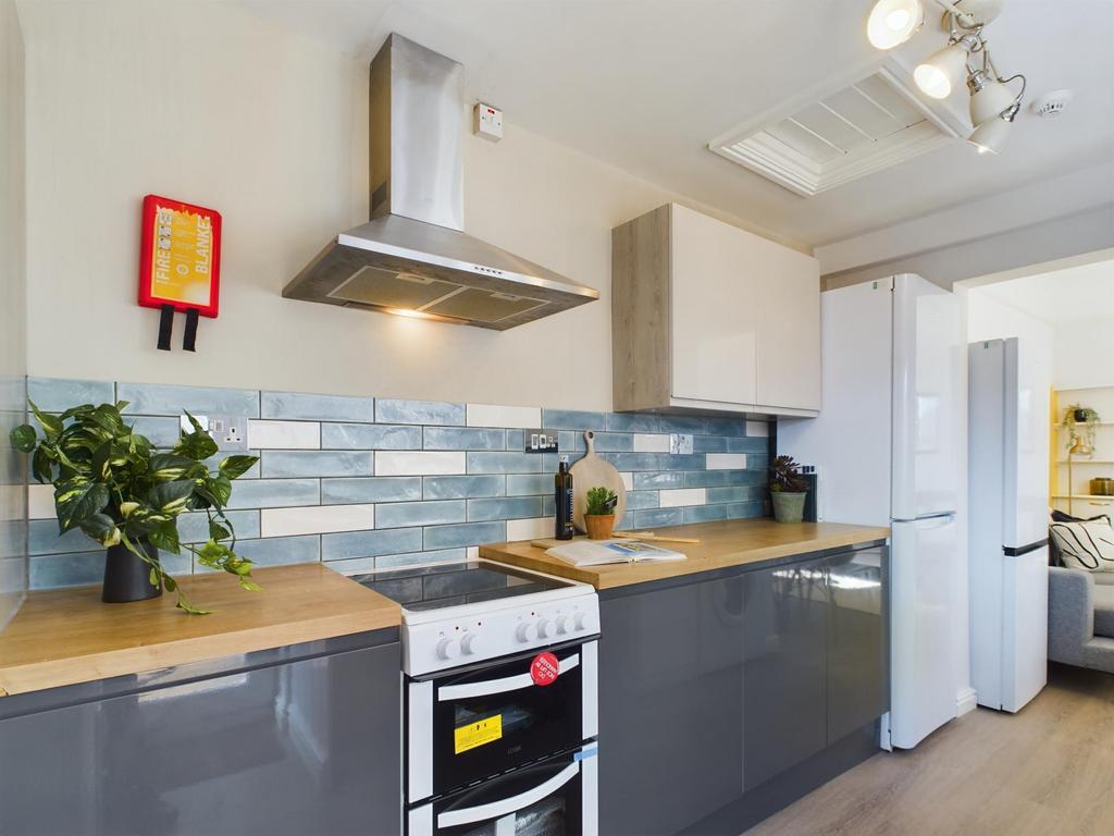 A bright and modern kitchen featuring ample cou...