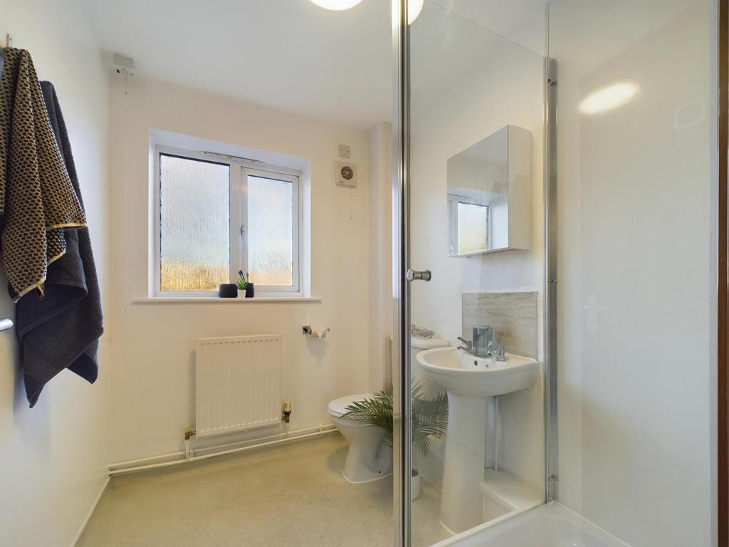 A modern and bright bathroom featuring a shower...