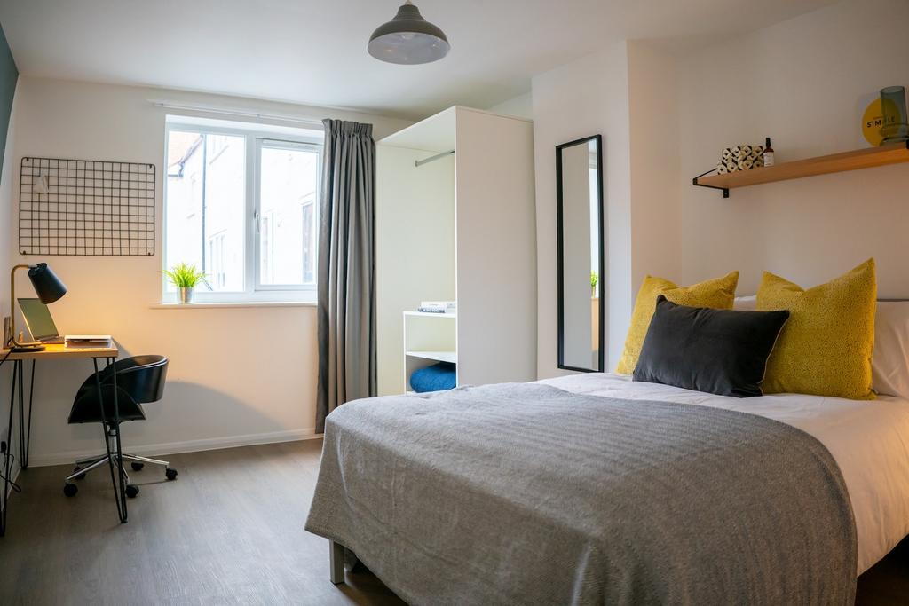 A bright and spacious double bedroom featuring ...