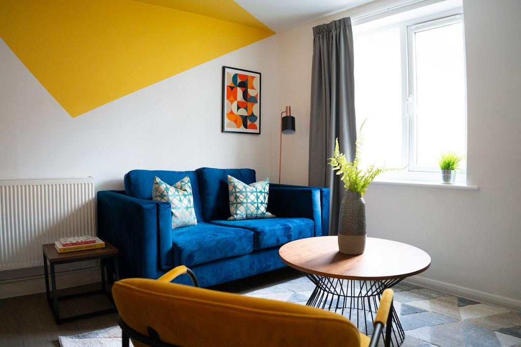 A stylish and bright living room featuring a co...