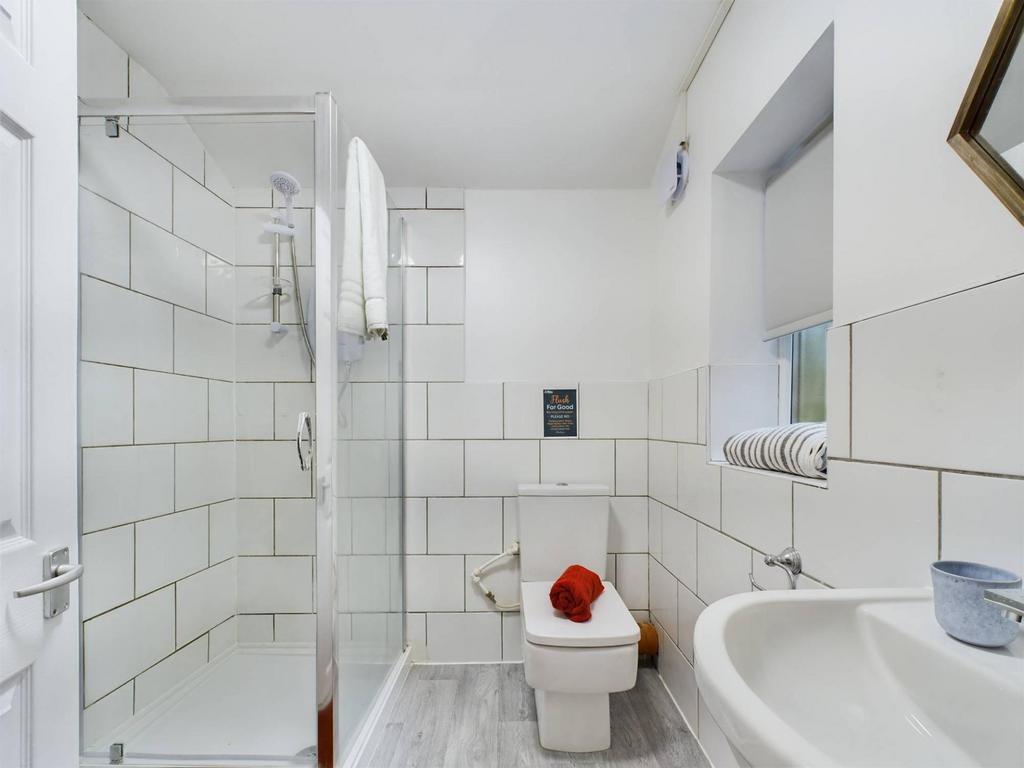 Bright, modern bathroom with a walk-in glass sh...