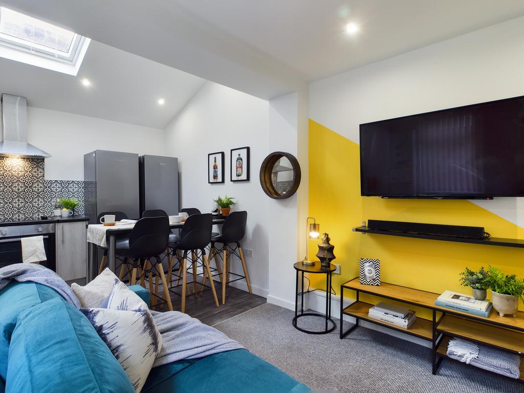 A bright and inviting large modern living room ...