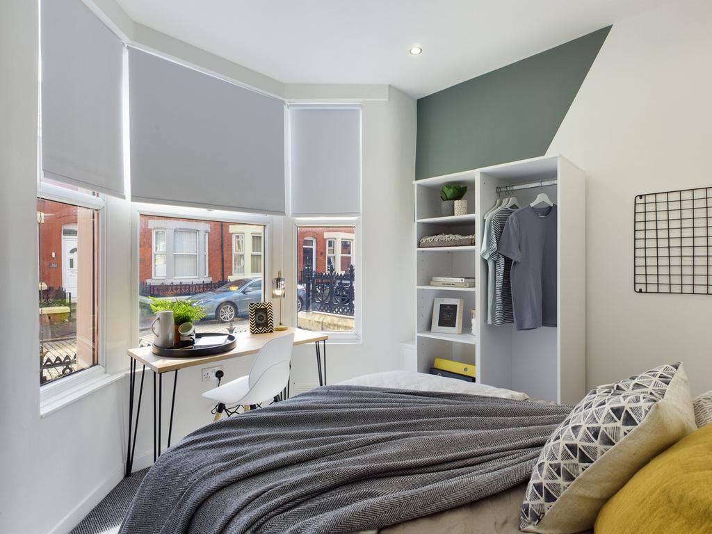 A bright and inviting double bedroom featuring ...