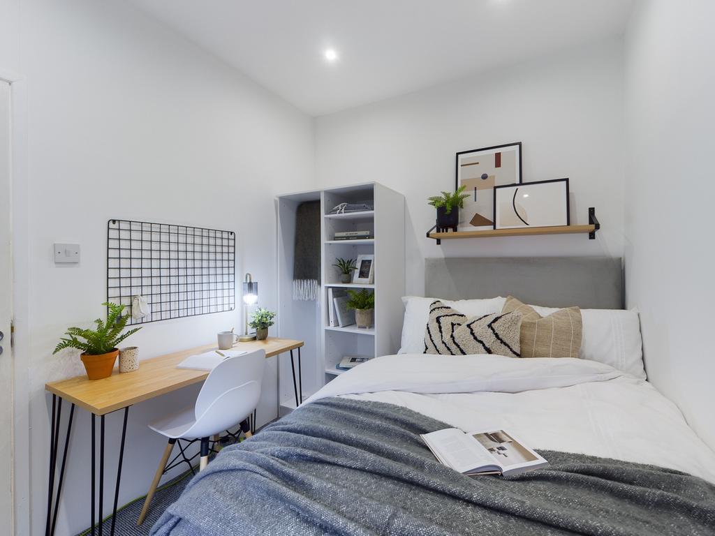 A bright and inviting double bedroom featuring ...