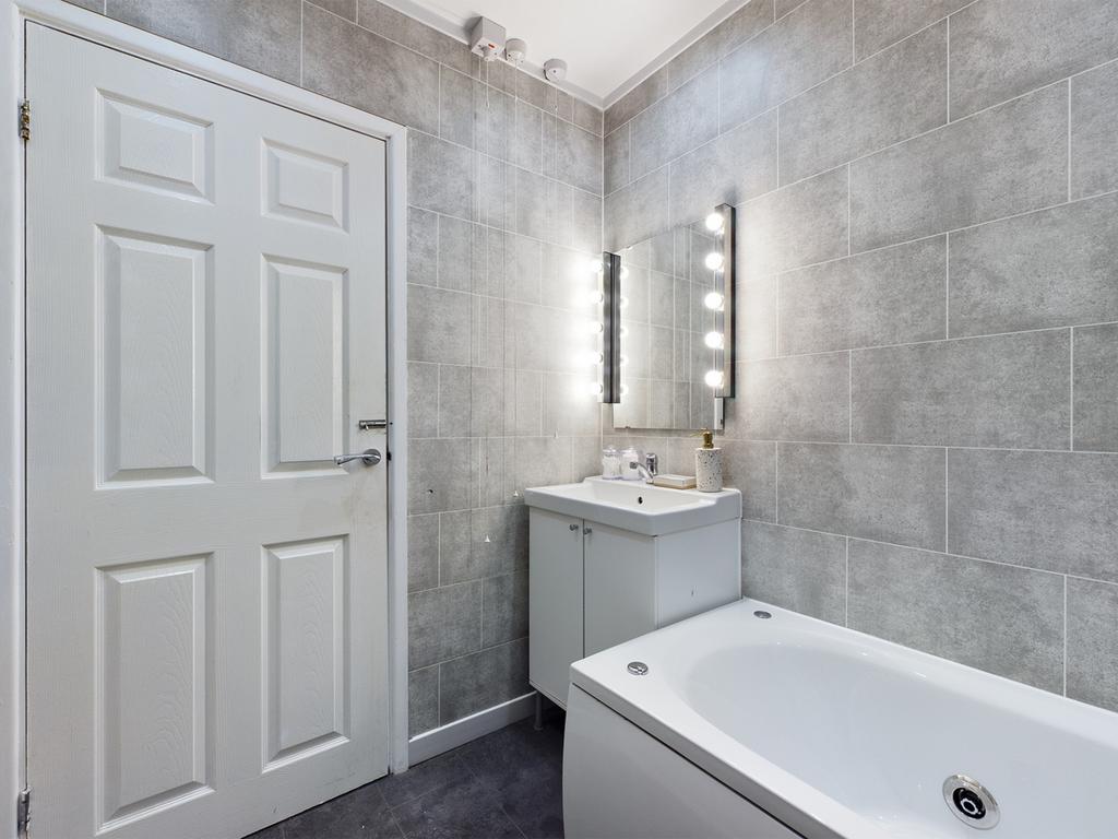 A modern and spacious bathroom featuring a styl...