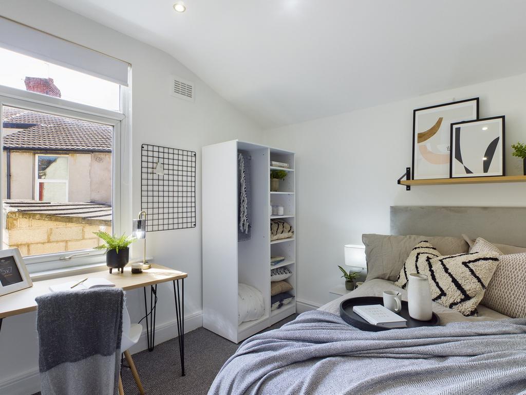 A bright and inviting double bedroom featuring ...