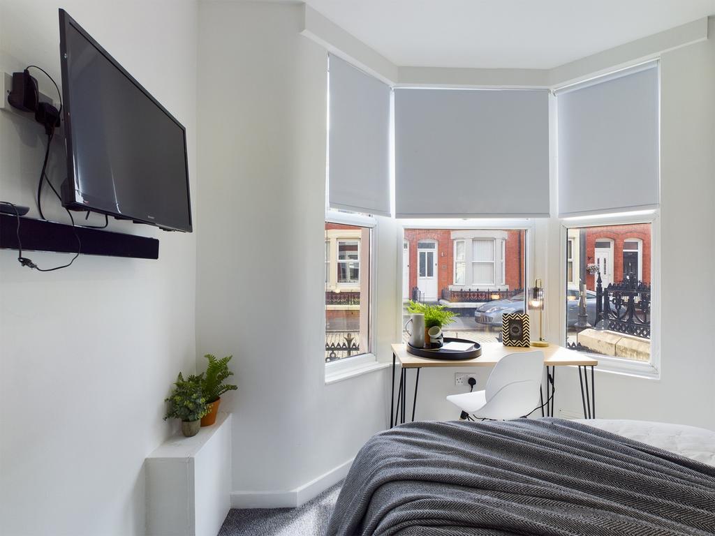 A bright and inviting double bedroom with large...