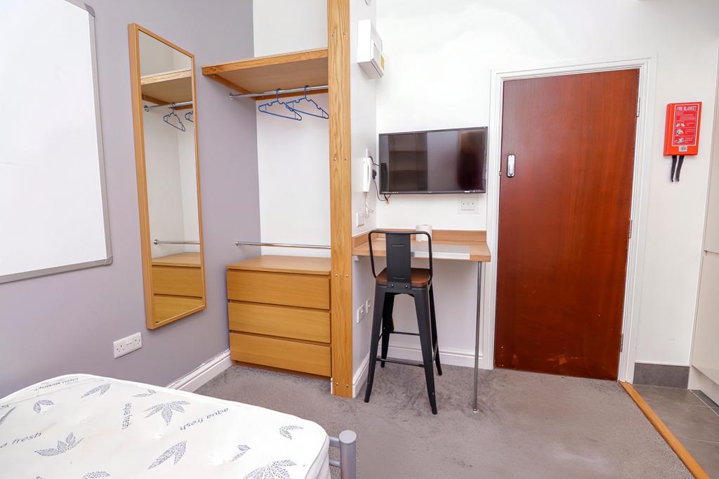 A modern and tidy double bedroom featuring a st...