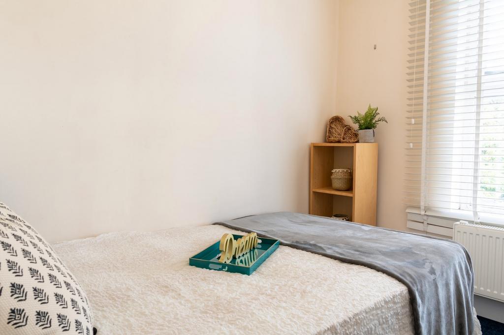 A cozy double bedroom featuring a comfortable b...