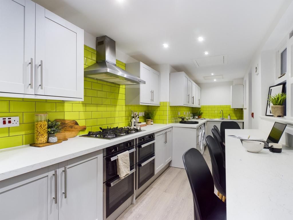 A modern and bright kitchenette featuring vibra...