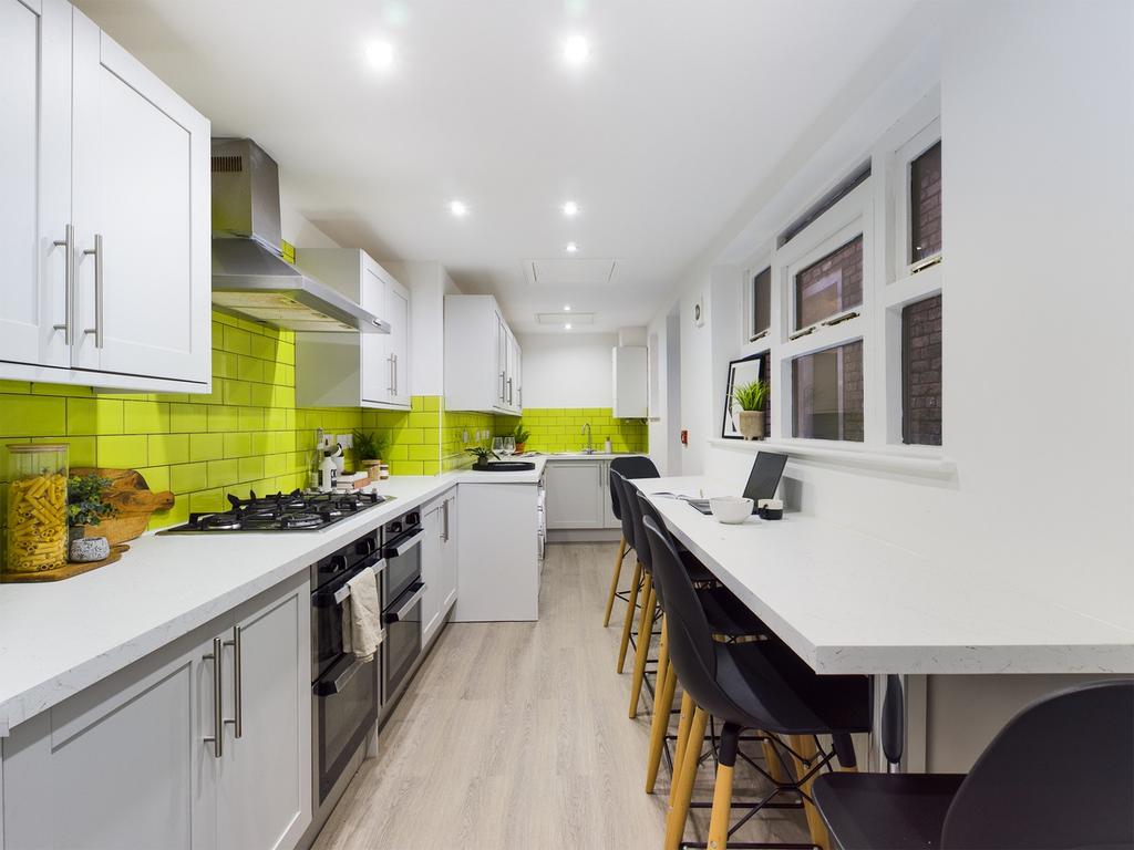 A modern and spacious kitchen with bright color...