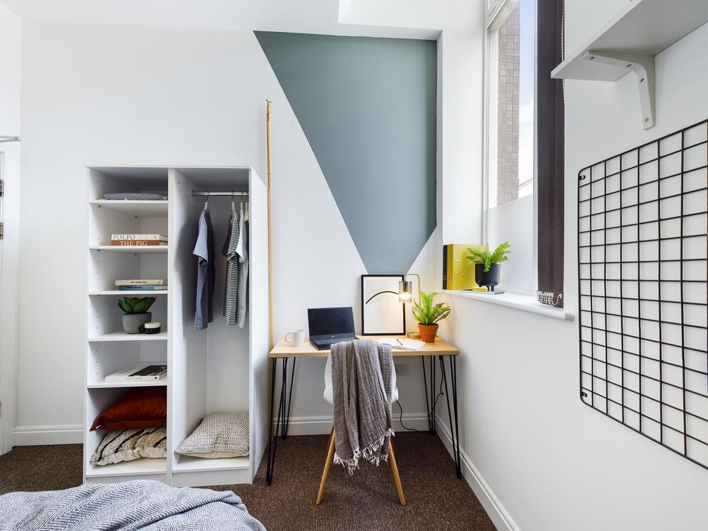 A bright and stylish double bedroom featuring a...