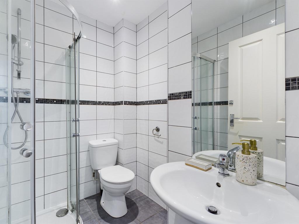 A modern and pristine bathroom featuring a styl...