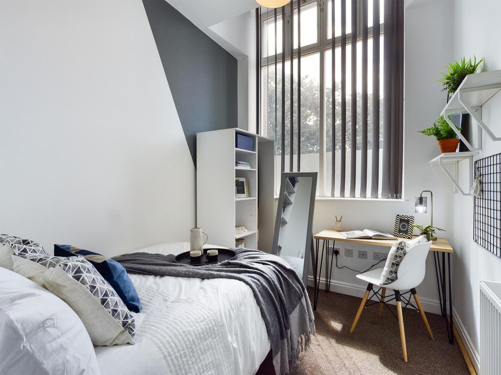 A bright and inviting double bedroom featuring ...