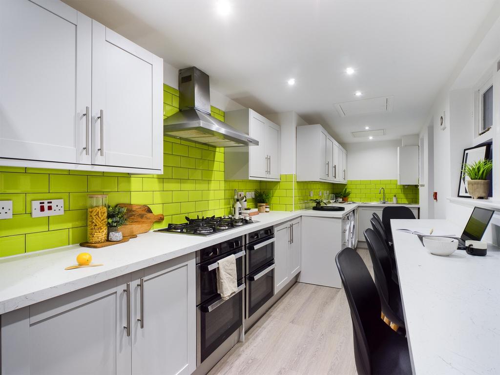 A modern and vibrant kitchen featuring sleek ca...