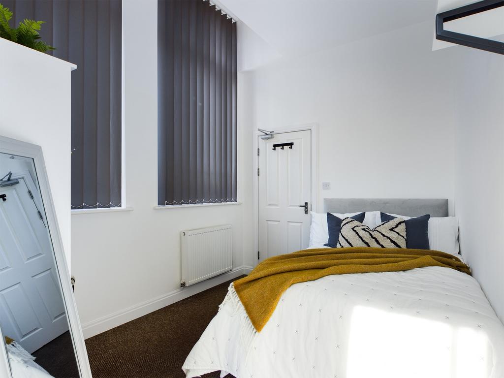 A stylish and bright double bedroom featuring l...