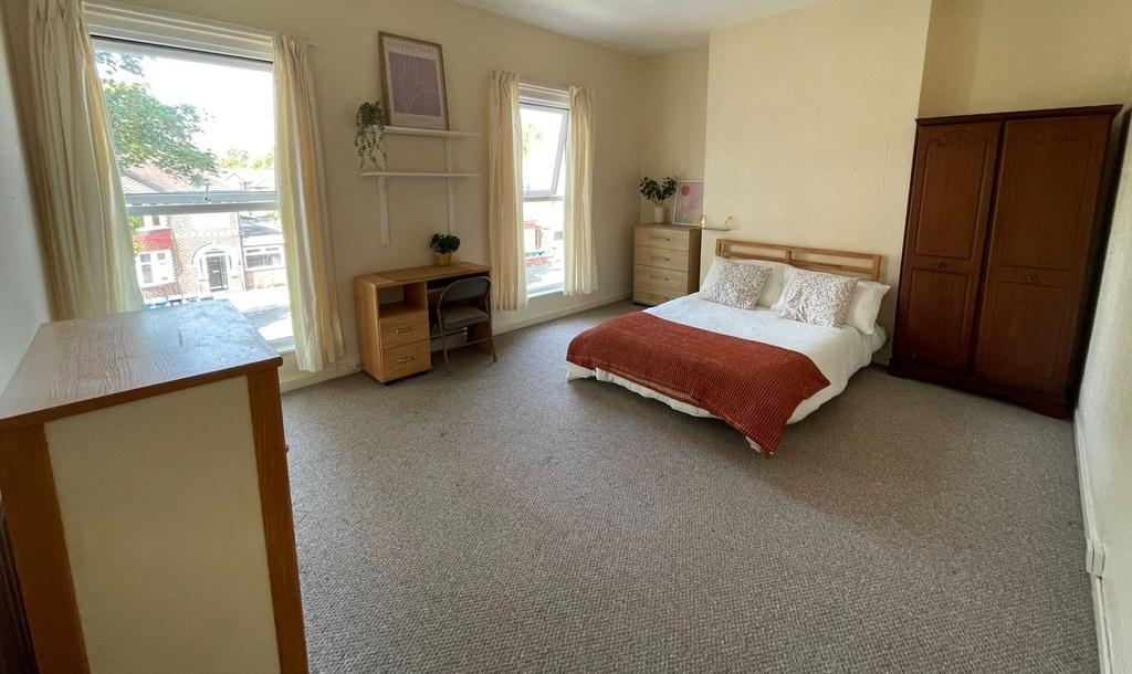 Bright and cozy bedroom featuring a double bed ...