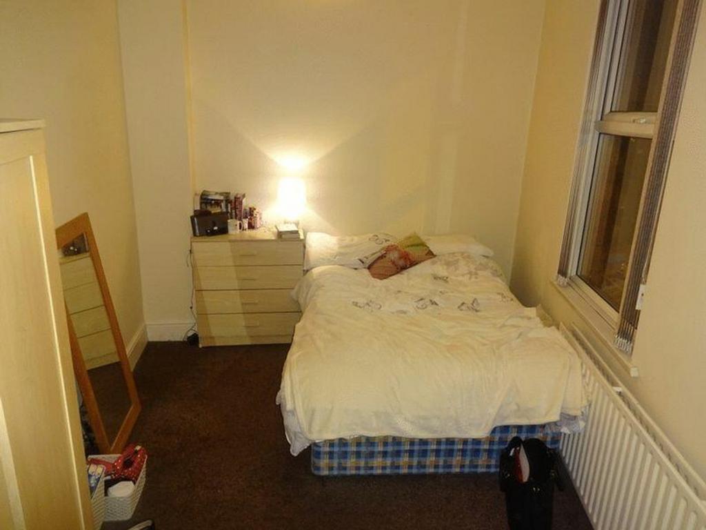 A cozy and inviting double bedroom, featuring a...