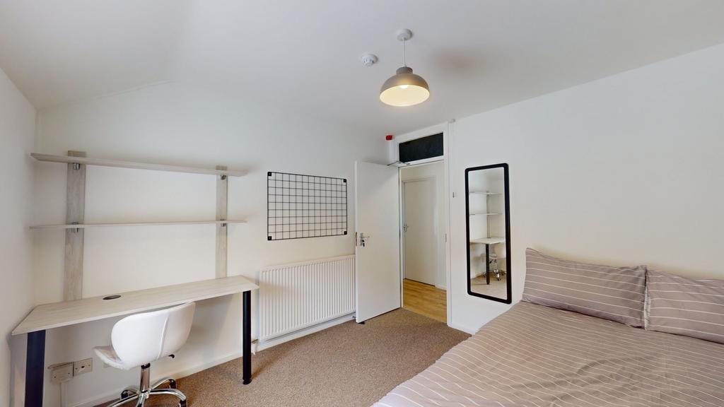 A bright and inviting double bedroom featuring ...
