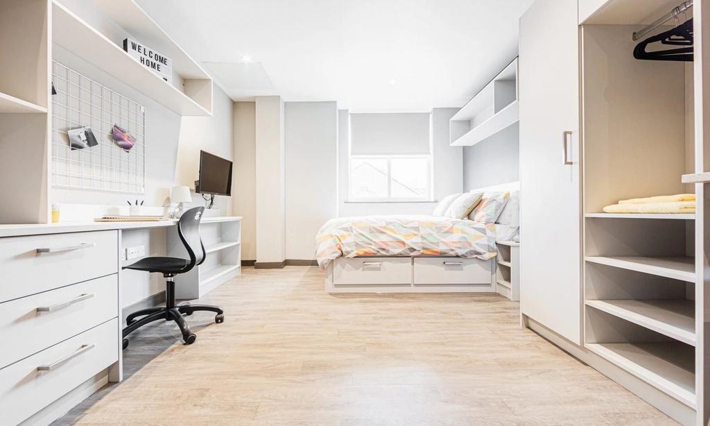 A bright and spacious double bedroom with moder...