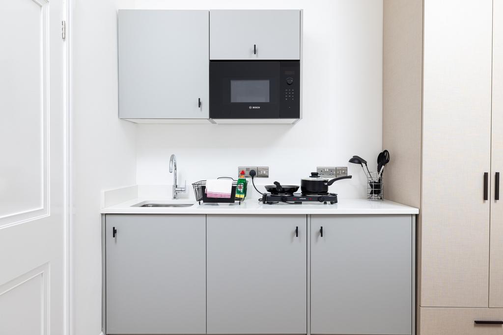 Modern kitchen featuring sleek cabinetry, a com...