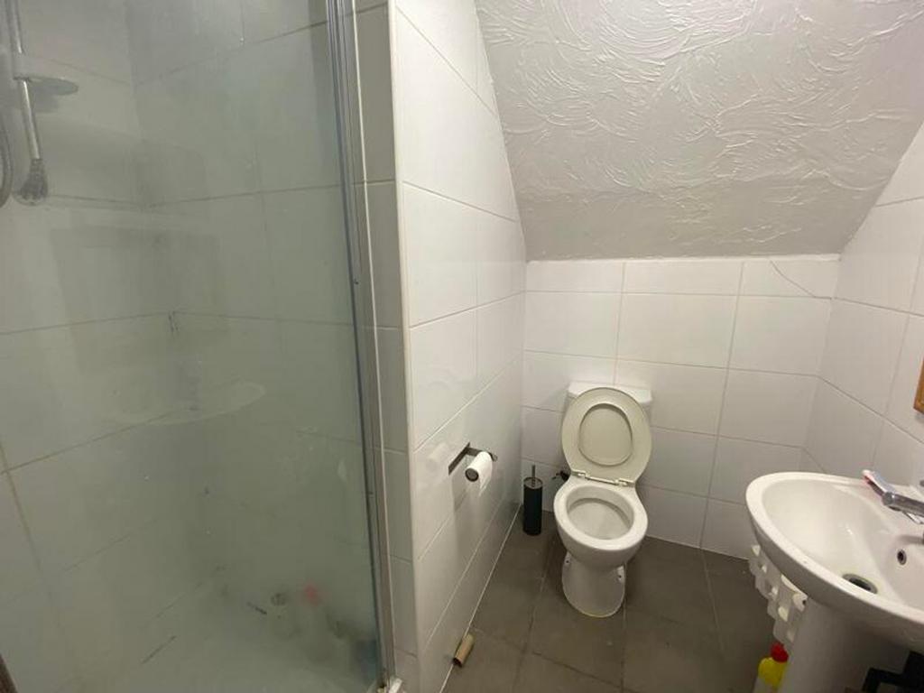 A well-maintained bathroom featuring a shower, ...