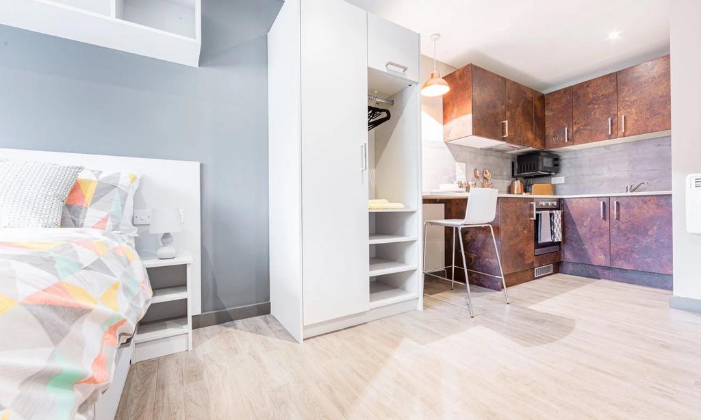 A bright and modern kitchenette with ample stor...