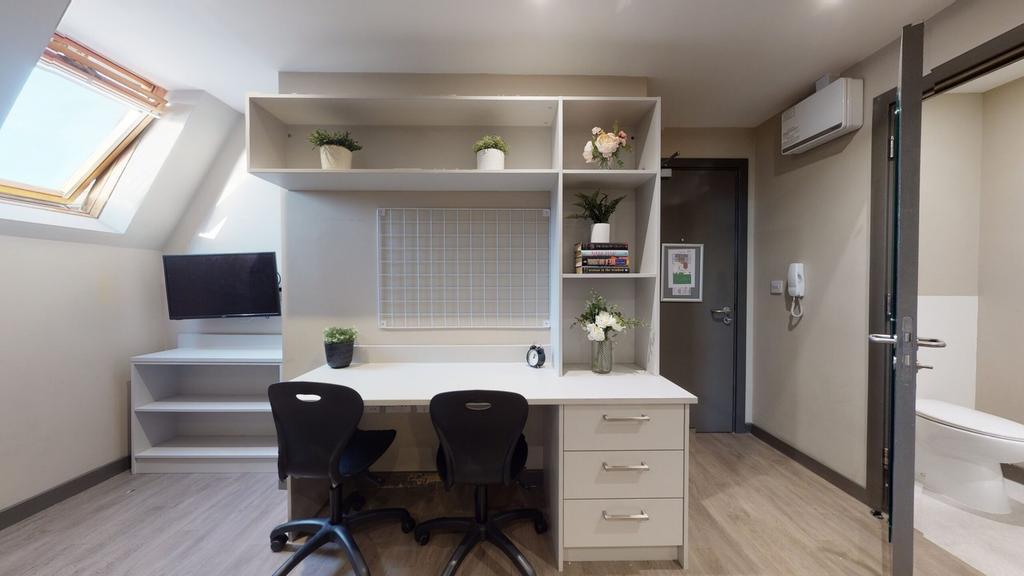 A bright and tidy communal workspace with ample...