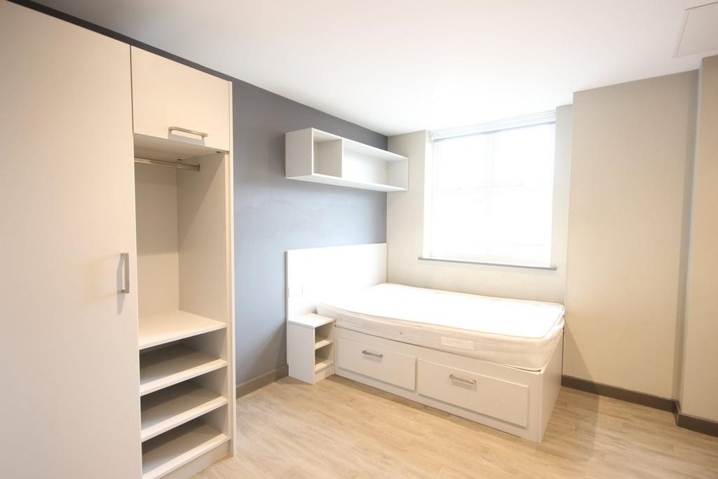 A bright and spacious double bedroom featuring ...