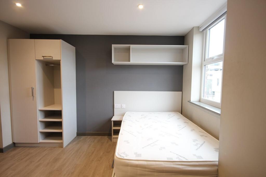 A spacious and bright double bedroom with moder...