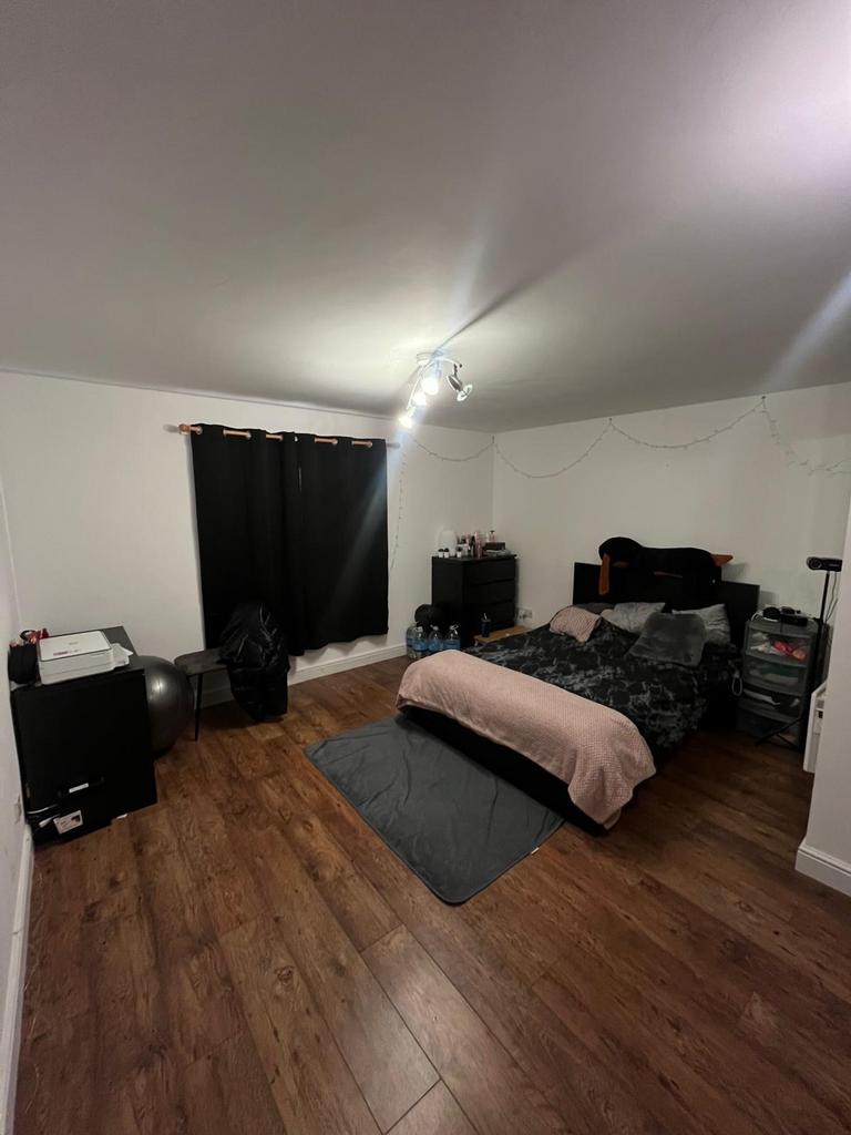 A spacious and inviting double bedroom featurin...