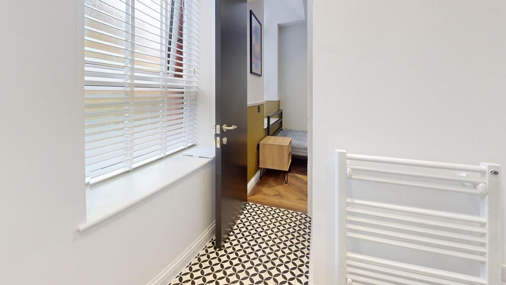 A bright and clean hallway with stylish floorin...