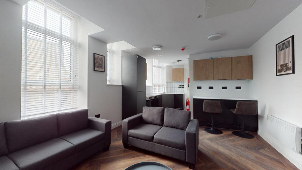 A spacious and contemporary living room with am...