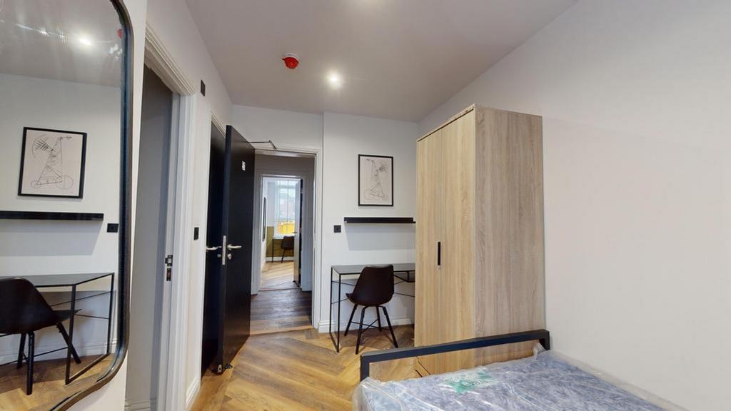 A stylish and well-lit double bedroom featuring...