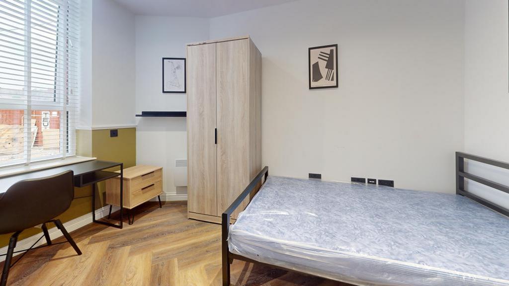A bright and spacious double bedroom featuring ...