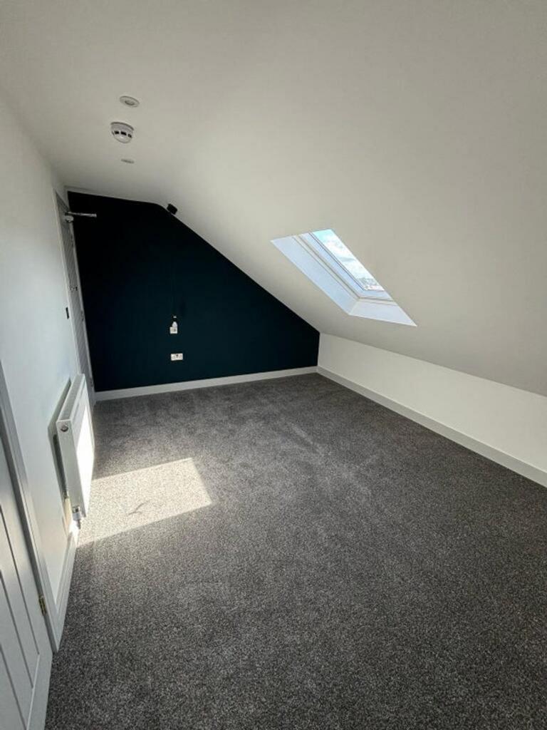 This charming double bedroom features a cozy at...