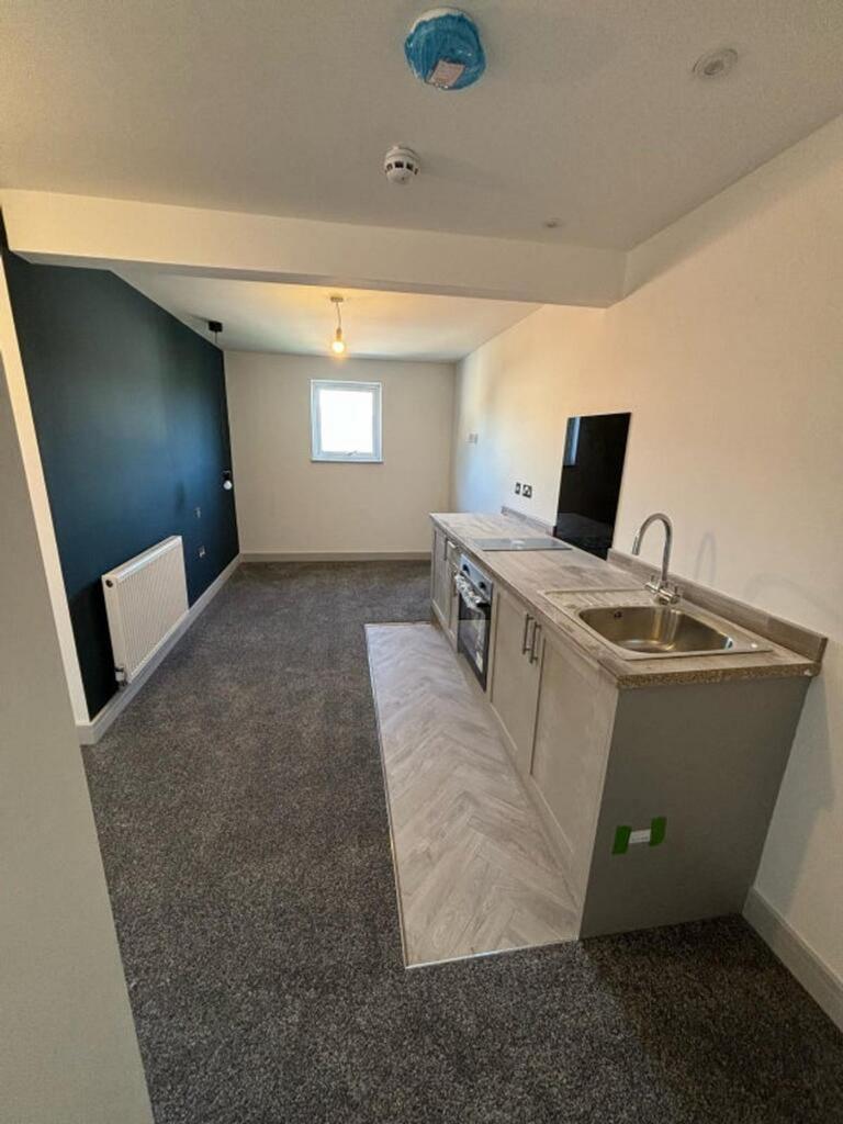 Modern kitchen featuring sleek countertops and ...