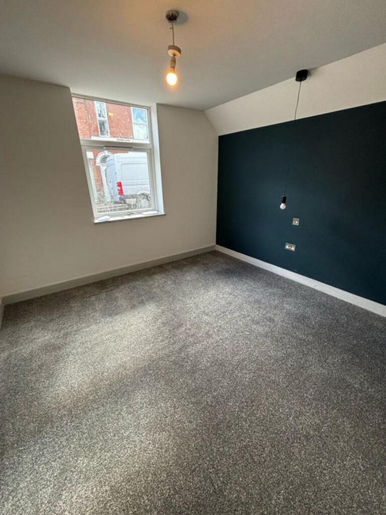 A bright and spacious double bedroom featuring ...