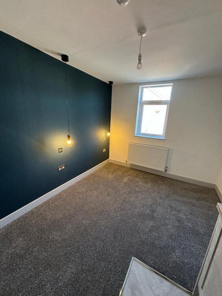 A stylish double bedroom featuring a modern des...