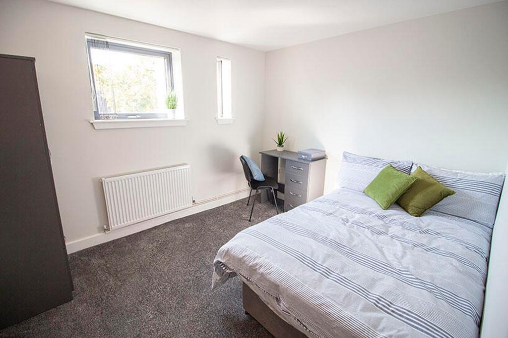 This inviting double bedroom features a cozy be...